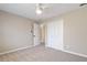 Neutral carpeted bedroom with white closet doors and ceiling fan at 909 Waterton Ct, Suwanee, GA 30024