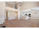 Open-concept living room and kitchen with hardwood floors and modern lighting at 909 Waterton Ct, Suwanee, GA 30024