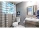Clean basement bathroom with toilet, sink, and shower at 2849 Crescendo Nw Dr, Atlanta, GA 30318