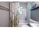 Clean bathroom with a shower/tub combo and floral shower curtain at 2849 Crescendo Nw Dr, Atlanta, GA 30318