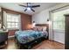 Cozy bedroom featuring wood floors and a rustic-style bed at 2849 Crescendo Nw Dr, Atlanta, GA 30318