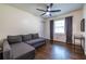 Multipurpose bedroom with a comfortable sofa and dark wood floors at 2849 Crescendo Nw Dr, Atlanta, GA 30318