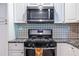 Stainless steel appliances and granite countertops in this galley kitchen at 2849 Crescendo Nw Dr, Atlanta, GA 30318