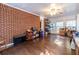 Spacious sunroom with brick accent wall and hardwood floors at 2849 Crescendo Nw Dr, Atlanta, GA 30318