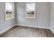Bright bedroom with two windows and wood flooring at 628 Ridge Rd, Dallas, GA 30157