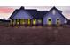 Two-story farmhouse with lighted windows at dusk at 628 Ridge Rd, Dallas, GA 30157