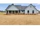 Two-story farmhouse with gray siding, covered porch, and brick accents at 628 Ridge Rd, Dallas, GA 30157