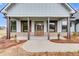 Covered front porch features wooden posts and a charming wood door at 628 Ridge Rd, Dallas, GA 30157