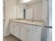 Double vanity bathroom with granite countertop and white cabinets, offering a modern design at 1491 Stephens View Dr, Loganville, GA 30052