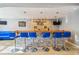 Modern basement bar with stone backsplash and blue barstools at 3352 Bartlett Ave, Conyers, GA 30013