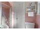 Pink tile bathroom with shower, toilet and built-in shelving at 1093 Lanier Ne Blvd, Atlanta, GA 30306