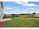Wide-open backyard with healthy green grass leading to a wooded area with new home construction at 123 Cherry Glen Way, Euharlee, GA 30145