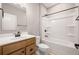 Clean bathroom with a bathtub and shower, wooden vanity, and a large mirror at 123 Cherry Glen Way, Euharlee, GA 30145