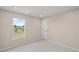 An empty bedroom featuring plush carpet and a bright window at 123 Cherry Glen Way, Euharlee, GA 30145