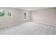 An empty bedroom with neutral walls, plush carpet, and bright windows at 123 Cherry Glen Way, Euharlee, GA 30145
