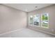 Bright bedroom featuring carpeted floors, neutral walls, and a set of large windows at 123 Cherry Glen Way, Euharlee, GA 30145