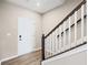 Foyer featuring a hardwood floor, white trim, and a staircase with a dark wood handrail at 123 Cherry Glen Way, Euharlee, GA 30145