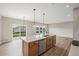 Open-concept kitchen includes a large island with a sink and bar seating, plus a view of the backyard at 123 Cherry Glen Way, Euharlee, GA 30145
