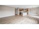 Open-concept living space with wood floors connecting the living room and kitchen at 123 Cherry Glen Way, Euharlee, GA 30145