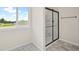 Bright shower room featuring light marble tile floor, large window and a glass shower at 123 Cherry Glen Way, Euharlee, GA 30145