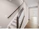 View of the staircase featuring neutral walls, wood-look flooring, and carpeted steps at 123 Cherry Glen Way, Euharlee, GA 30145