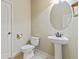 Updated bathroom with pedestal sink, oval mirror, and neutral colors at 289 Madison Park Dr, Grayson, GA 30017