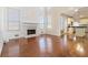 Spacious living room with hardwood floors, fireplace, and views into the kitchen at 4140 Cherry Ridge Walk, Suwanee, GA 30024