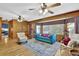 Spacious living room featuring hardwood floors, a comfy couch, and large windows at 872 Brafferton Pl, Stone Mountain, GA 30083