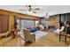 Living room with teal couch, wood-paneled walls, and fireplace at 872 Brafferton Pl, Stone Mountain, GA 30083