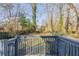 View from deck shows fenced backyard with mature trees at 2599 Browns Mill Se Rd, Atlanta, GA 30354