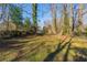 Large backyard with mature trees and grassy area at 2599 Browns Mill Se Rd, Atlanta, GA 30354