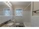 Clean bathroom with white tile and granite vanity at 2599 Browns Mill Se Rd, Atlanta, GA 30354