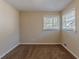 Well-lit bedroom with neutral walls and carpet, and two windows at 2599 Browns Mill Se Rd, Atlanta, GA 30354