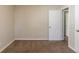 Simple bedroom with neutral walls, carpet, and access to other rooms at 2599 Browns Mill Se Rd, Atlanta, GA 30354