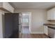 Kitchen with stainless steel refrigerator and view into adjacent room at 2599 Browns Mill Se Rd, Atlanta, GA 30354
