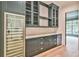 Butler's pantry with dark gray cabinets, quartz countertops, wine cooler, and beverage fridge at 590 Clubwood Ct, Marietta, GA 30068