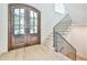 Elegant entryway with arched double doors, hardwood floors, and a grand staircase at 590 Clubwood Ct, Marietta, GA 30068