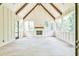 Sunroom with white shiplap walls, stone flooring, and a fireplace at 590 Clubwood Ct, Marietta, GA 30068