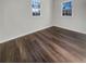 This bedroom has hardwood floors and two windows, providing ample natural light at 555 Bridge Ave, Forest Park, GA 30297
