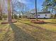 Lovely single-story home with a screened-in porch, set on a grassy lot with mature trees at 555 Bridge Ave, Forest Park, GA 30297