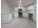 Modern kitchen with white cabinetry, stainless steel appliances, and a spacious layout, perfect for cooking and entertaining at 555 Bridge Ave, Forest Park, GA 30297