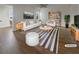 Bright living room features modern furnishings, neutral decor, and stylish accents in a comfortable layout, virtually staged at 555 Bridge Ave, Forest Park, GA 30297