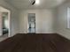 Open living room with ceiling fan, wood floors, and views into the kitchen at 555 Bridge Ave, Forest Park, GA 30297