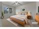 Inviting primary bedroom featuring neutral tones, a comfortable bed, and natural light for a restful ambiance; virtually staged at 555 Bridge Ave, Forest Park, GA 30297