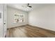 Well-lit bedroom with modern ceiling fan, hardwood floors, and a large window at 3603 Brycewood Dr, Decatur, GA 30034