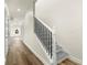 Bright hallway showcasing hardwood floors and a staircase with white rails and black spindles at 3603 Brycewood Dr, Decatur, GA 30034