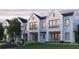 Three-unit townhome building, white brick exterior, landscaping, and a grassy lawn at 1341 Grannysmith Trce # 45, Brookhaven, GA 30319