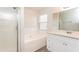 Bathroom boasts a garden tub, stand-up shower, and white vanity at 850 Oxford Hall Dr, Lawrenceville, GA 30044
