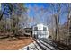 Two-story house with driveway and wooded setting at 850 Oxford Hall Dr, Lawrenceville, GA 30044