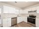 Updated kitchen with white cabinets, stainless steel appliances, and L-shaped counters at 850 Oxford Hall Dr, Lawrenceville, GA 30044